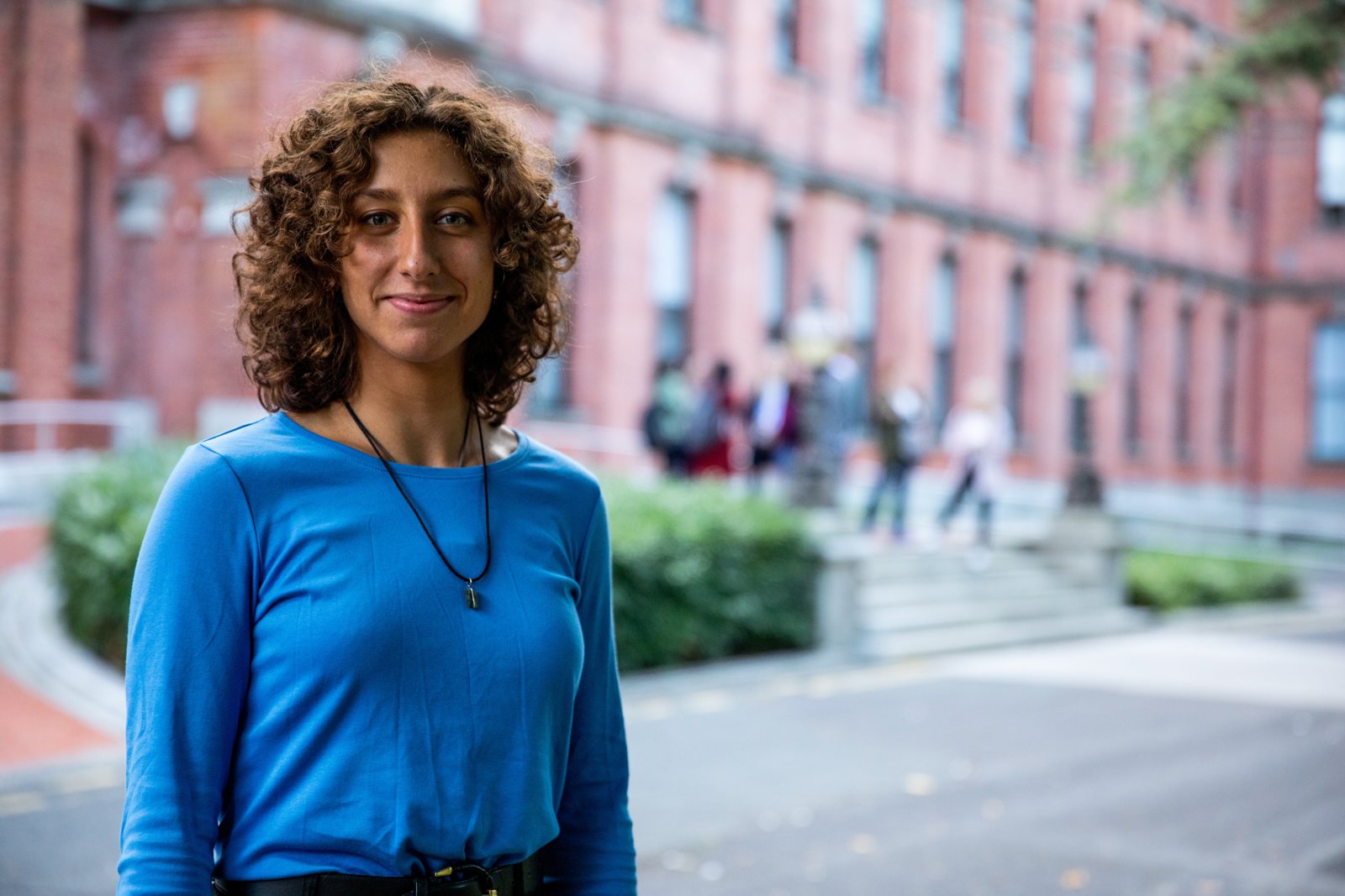 Kambo practitioner Melania smiling in a blue shirt